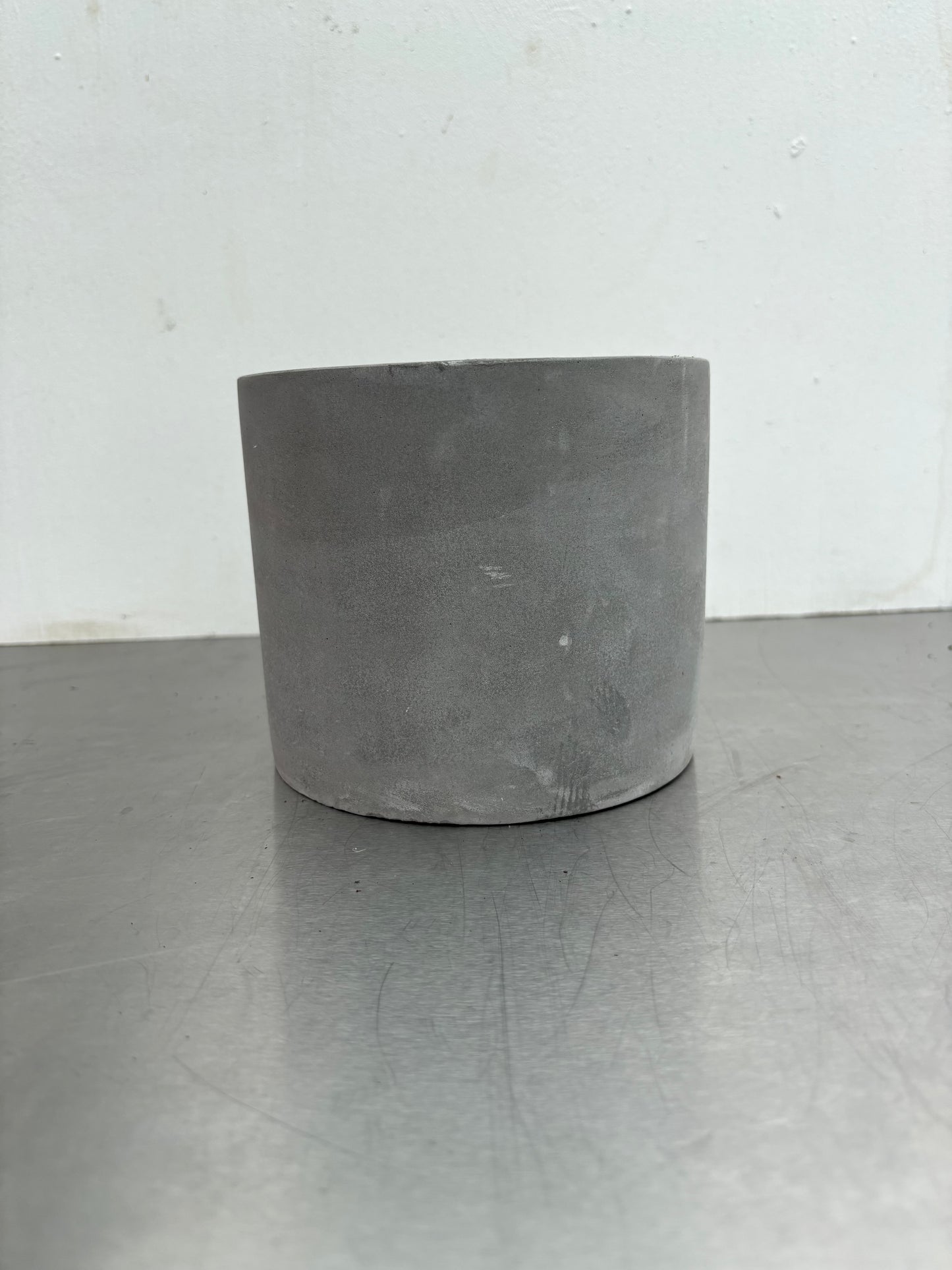 12 cm Grey Concrete Pot with smooth matte finish, ideal for modern indoor plant decor in home or office settings.